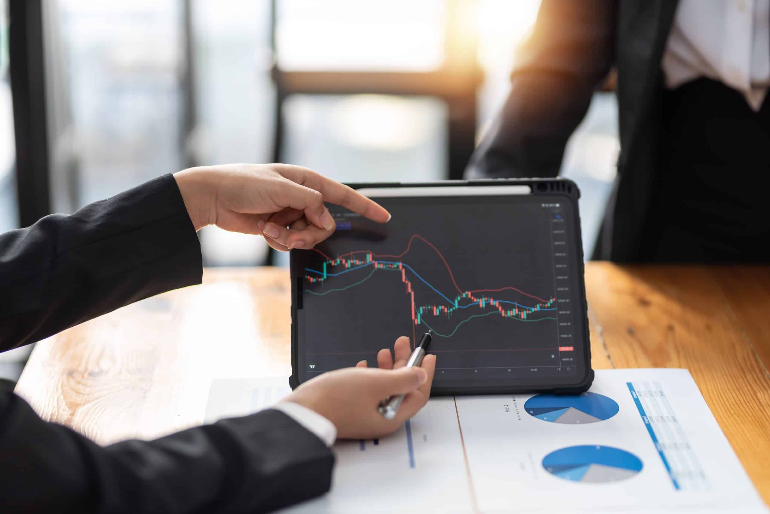 Investor team analyzes the stock market on a tablet at the meeti